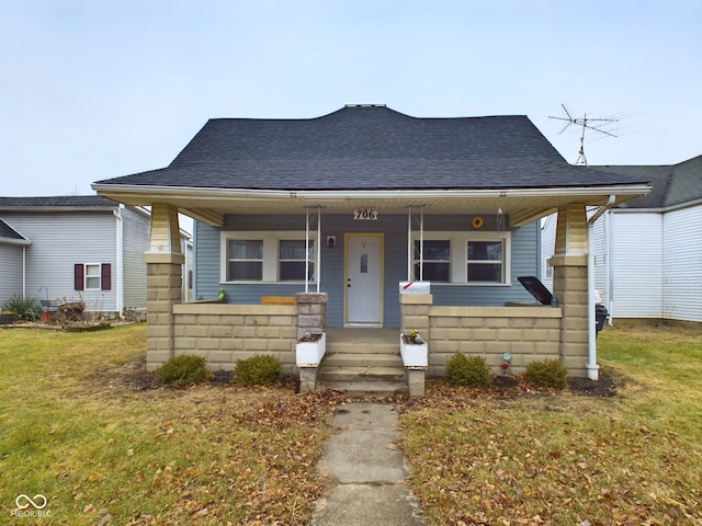 bungalow-style home with a porch and a front lawn