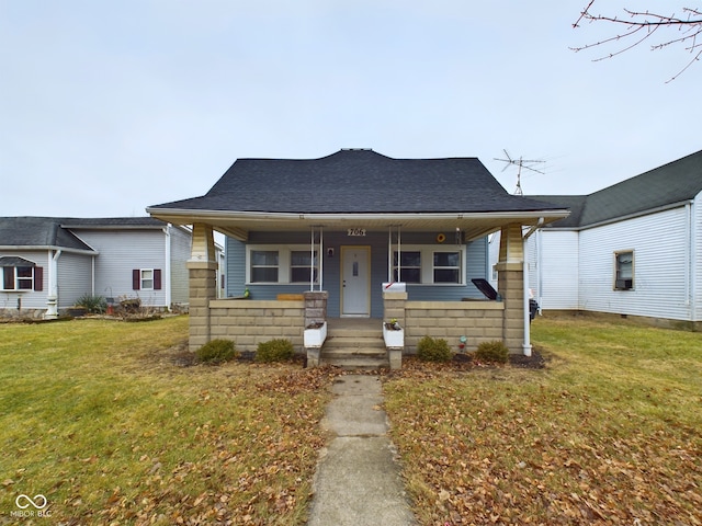 bungalow with a porch and a front lawn