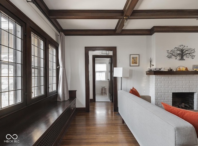 interior space featuring baseboards, coffered ceiling, beam ceiling, a fireplace, and dark wood-type flooring