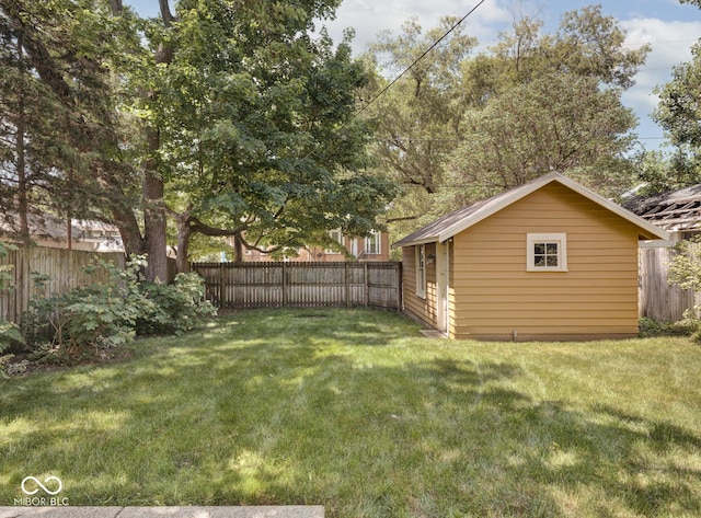 view of yard with an outdoor structure and a fenced backyard