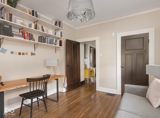 office space with visible vents, a notable chandelier, dark wood-type flooring, ornamental molding, and baseboards