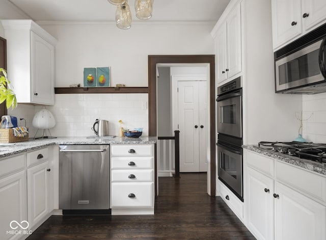 kitchen with light stone counters, stainless steel appliances, dark wood-style floors, and white cabinets