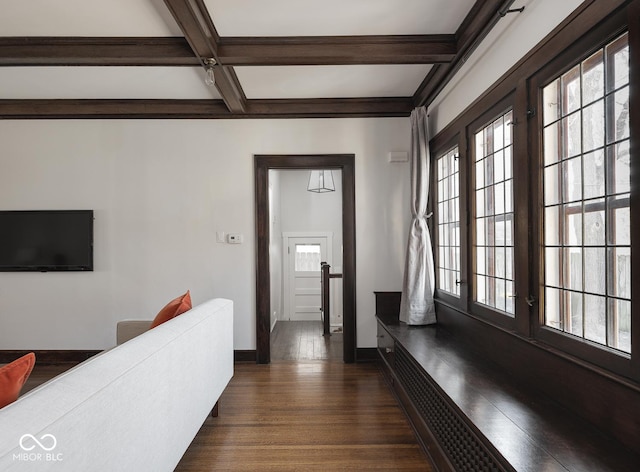 hallway featuring dark wood finished floors, beamed ceiling, coffered ceiling, and baseboards