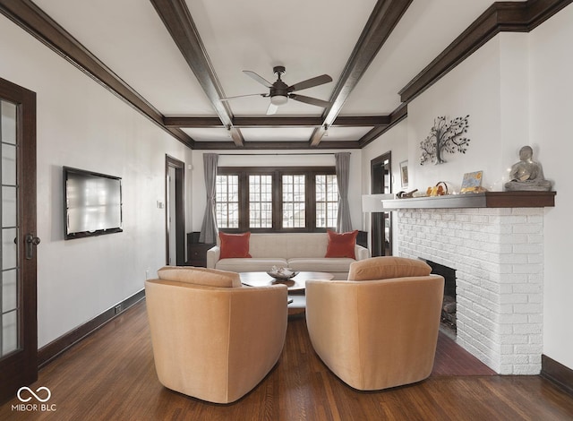 living room featuring dark wood-style floors, beamed ceiling, baseboards, coffered ceiling, and a brick fireplace