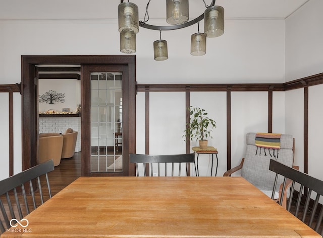 dining room with crown molding and wood finished floors