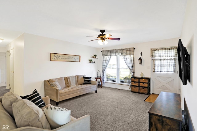 living room featuring ceiling fan and carpet