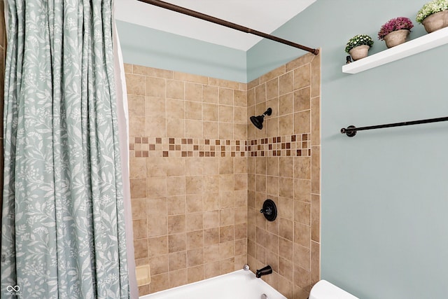 bathroom with shower / bath combo and toilet