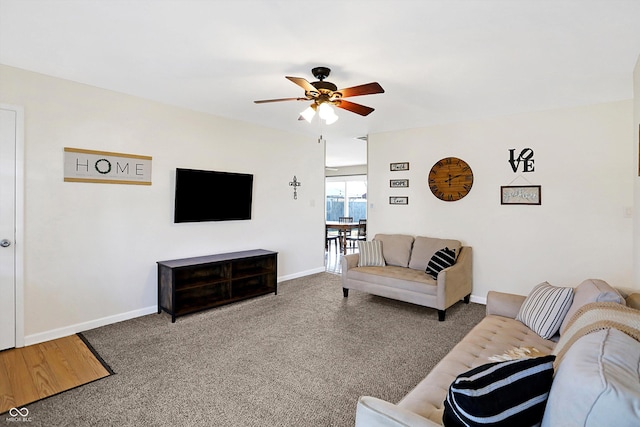 living room featuring carpet flooring and ceiling fan