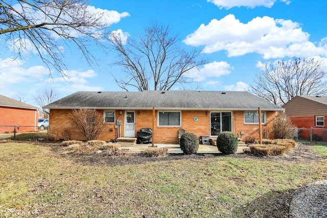 rear view of house with a yard and a patio