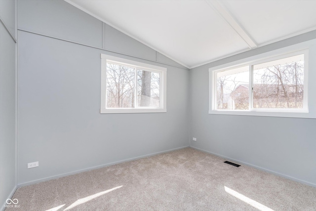 unfurnished bedroom with lofted ceiling, carpet floors, multiple windows, and visible vents