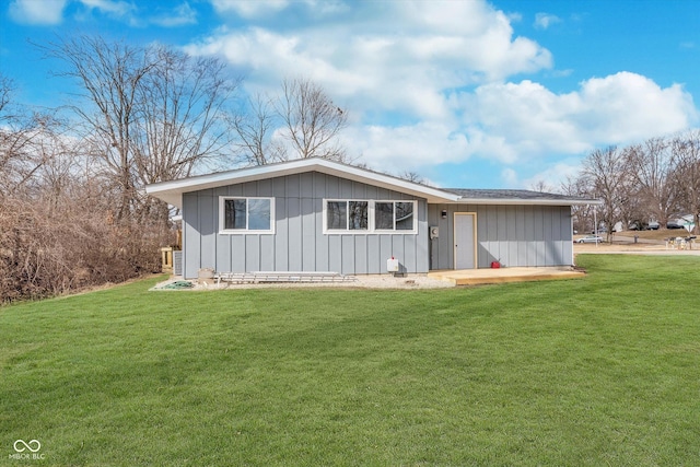 view of front facade featuring board and batten siding and a front yard