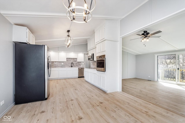 kitchen featuring vaulted ceiling with beams, tasteful backsplash, white cabinets, and stainless steel appliances