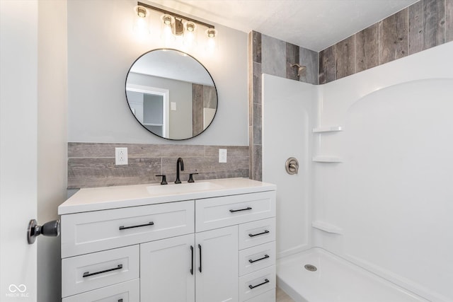 full bathroom featuring walk in shower and vanity