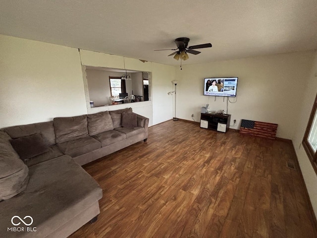 living room featuring a textured ceiling, wood-type flooring, and ceiling fan