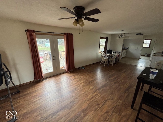 interior space featuring ceiling fan, dark hardwood / wood-style floors, a textured ceiling, and french doors