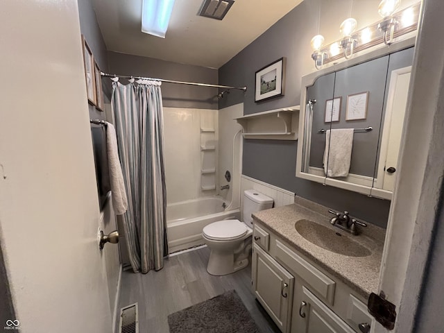 bathroom with vanity, shower / bath combination with curtain, toilet, visible vents, and wood finished floors