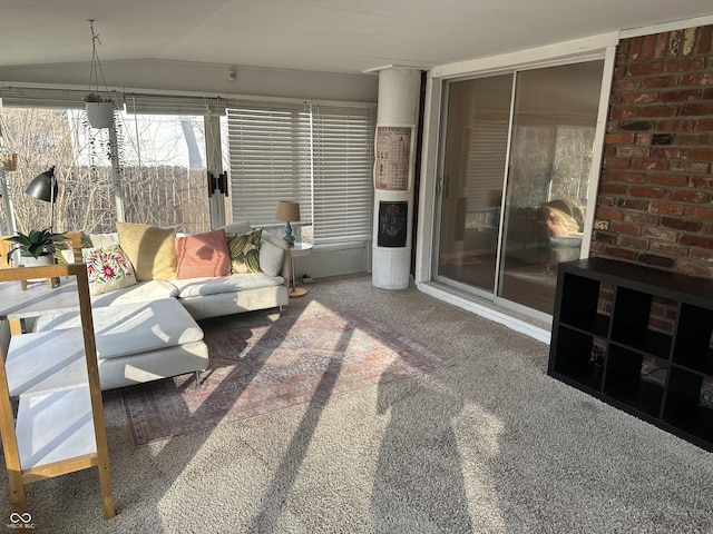 carpeted living room featuring vaulted ceiling