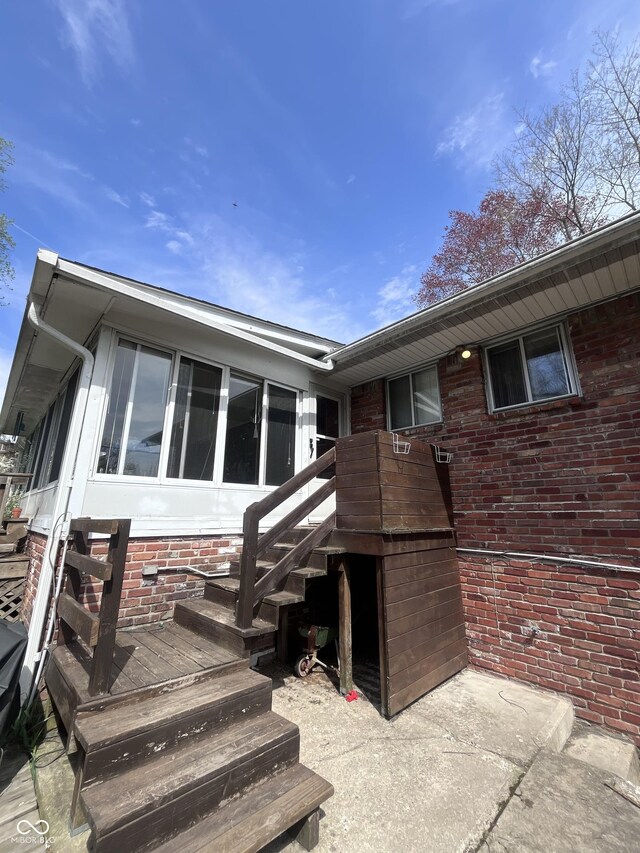 back of house featuring brick siding