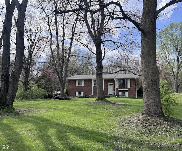 view of front of house featuring a front yard and brick siding