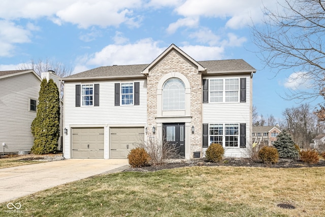 view of front of home with a front yard and a garage