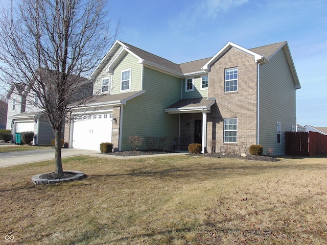 view of property with a garage and a front lawn