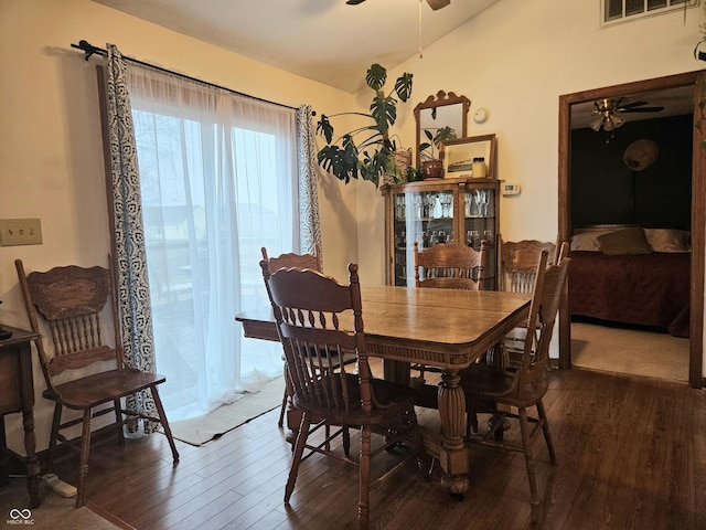 dining room featuring lofted ceiling, dark hardwood / wood-style flooring, and ceiling fan