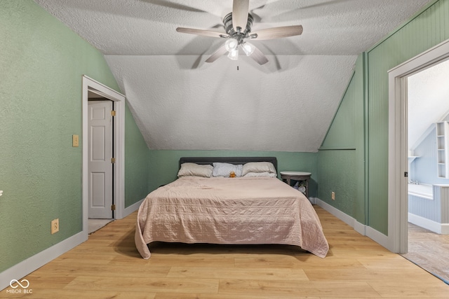 bedroom with lofted ceiling, ceiling fan, light hardwood / wood-style flooring, and a textured ceiling