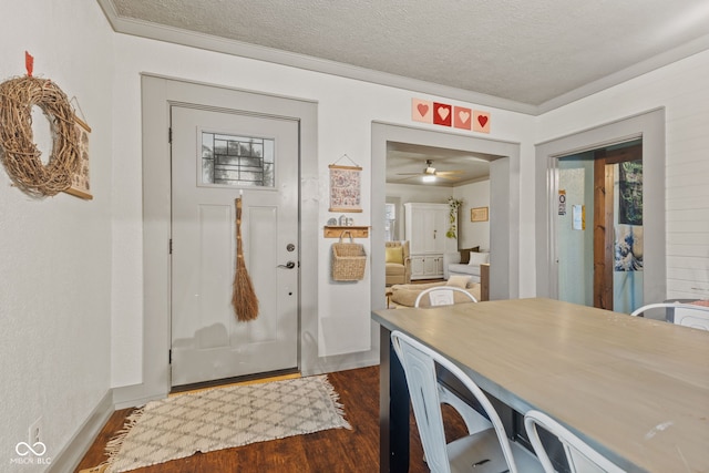 interior space with crown molding, dark hardwood / wood-style floors, and a textured ceiling