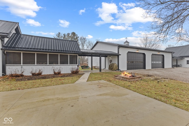 view of front of house with a garage, a front lawn, and a sunroom