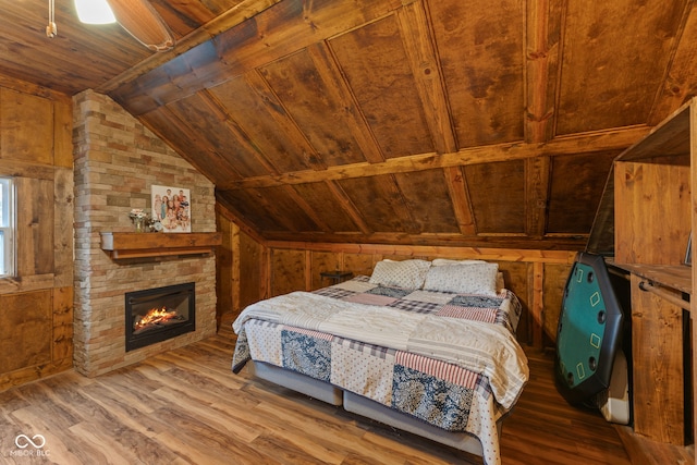 unfurnished bedroom with wood-type flooring, lofted ceiling, wooden ceiling, and wood walls