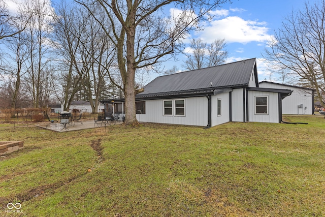 back of property featuring a yard and a patio area
