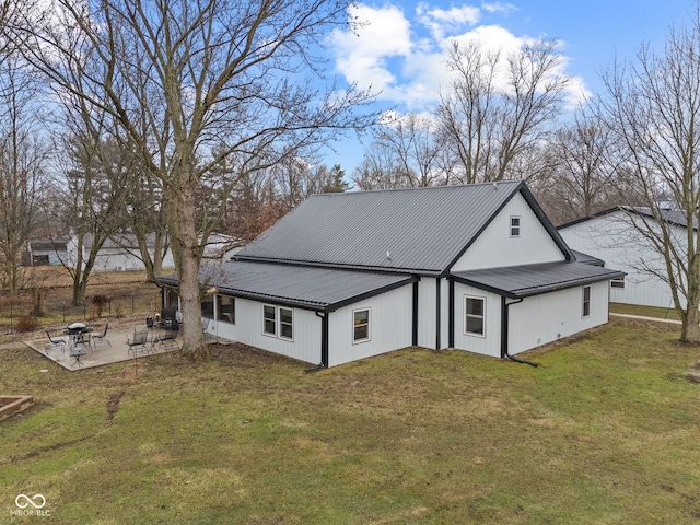 rear view of property with a yard and a patio area