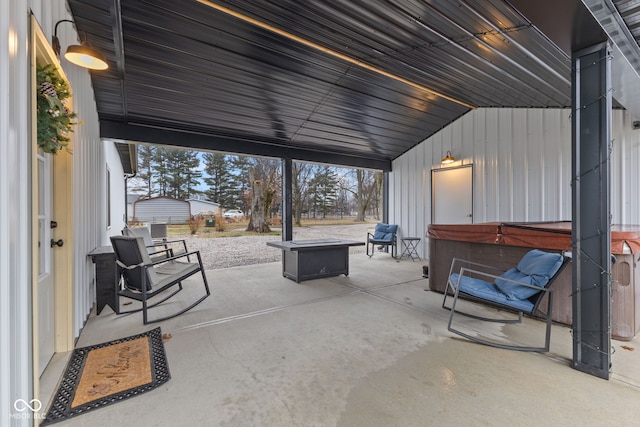 view of patio featuring a hot tub and a fire pit