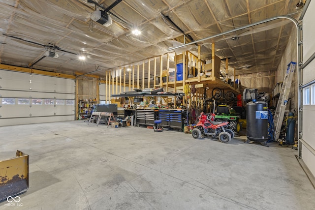 garage with a garage door opener and a workshop area