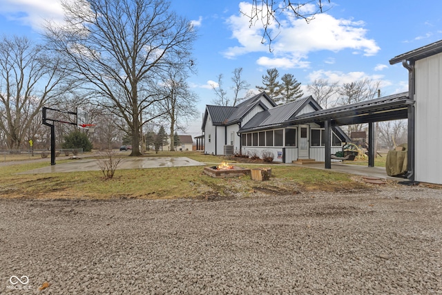view of side of property with a carport and a sunroom