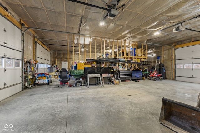 garage with a garage door opener and a workshop area
