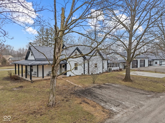 view of front of house with a porch, a garage, and a front lawn
