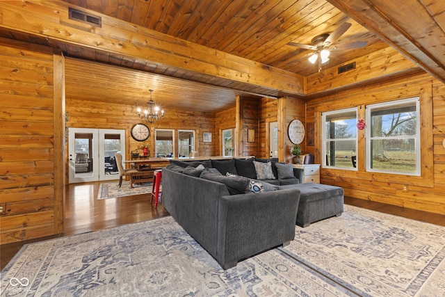 living room with french doors, wood walls, wooden ceiling, dark hardwood / wood-style floors, and ceiling fan with notable chandelier