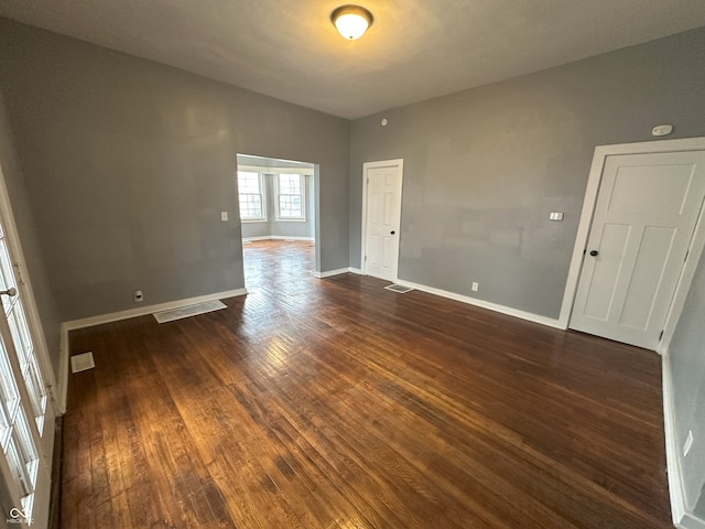 unfurnished room featuring dark hardwood / wood-style flooring