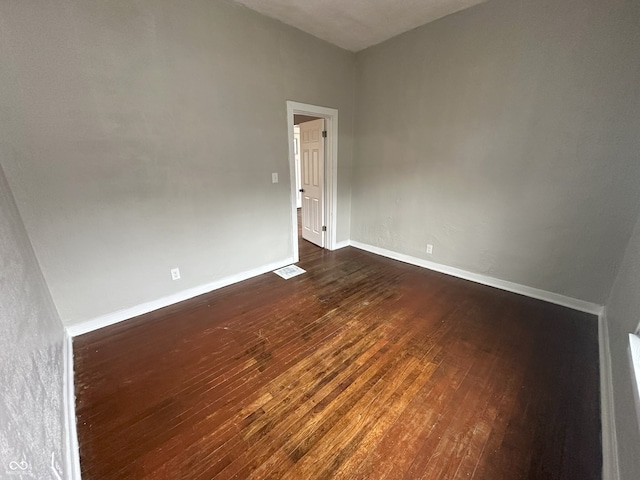 spare room with dark hardwood / wood-style flooring