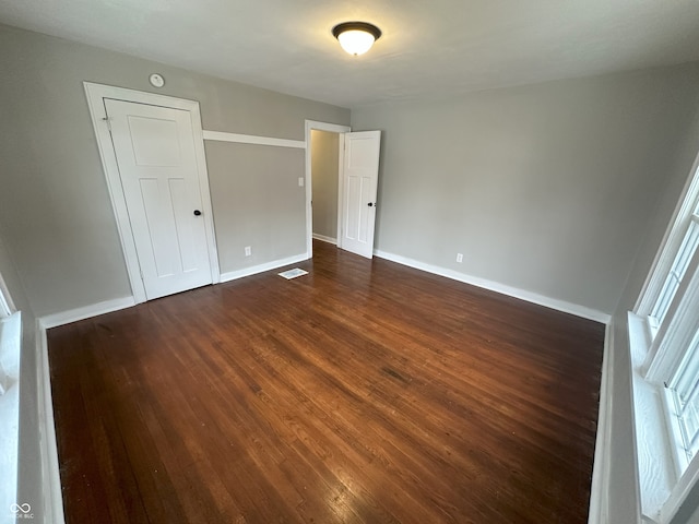 empty room with dark wood-type flooring