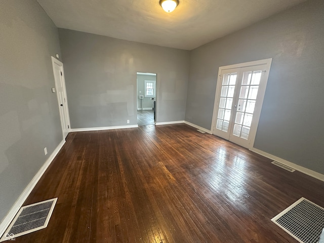 empty room with french doors and dark hardwood / wood-style flooring