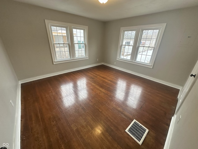 empty room with dark hardwood / wood-style floors