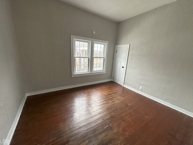 unfurnished room featuring dark hardwood / wood-style floors