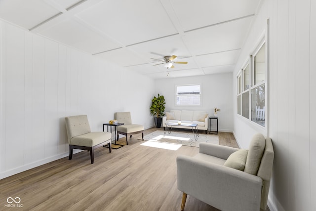 living room featuring coffered ceiling, ceiling fan, and light wood-type flooring