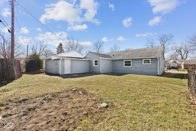 rear view of house with a yard