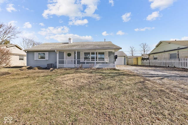 single story home featuring central AC, a porch, and a front yard