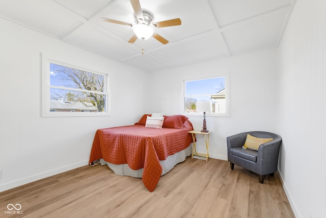 bedroom with ceiling fan, coffered ceiling, and light wood-type flooring