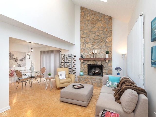 living room with a fireplace, high vaulted ceiling, and light parquet floors