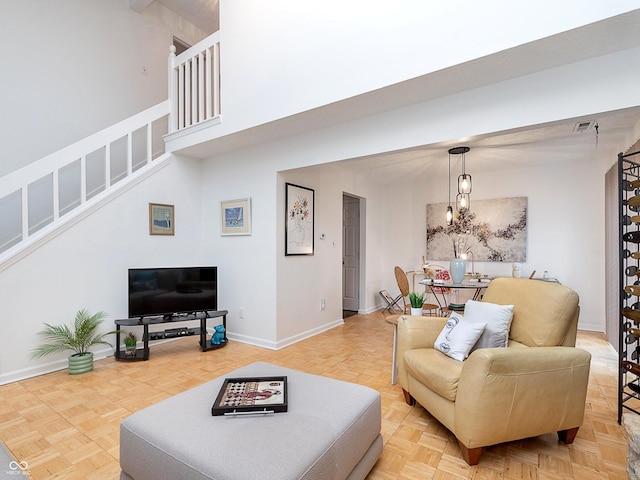 living room with parquet floors and a high ceiling